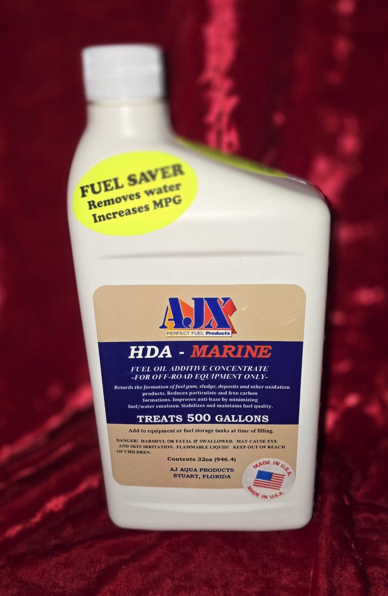 Fuel additive bottle against red background.