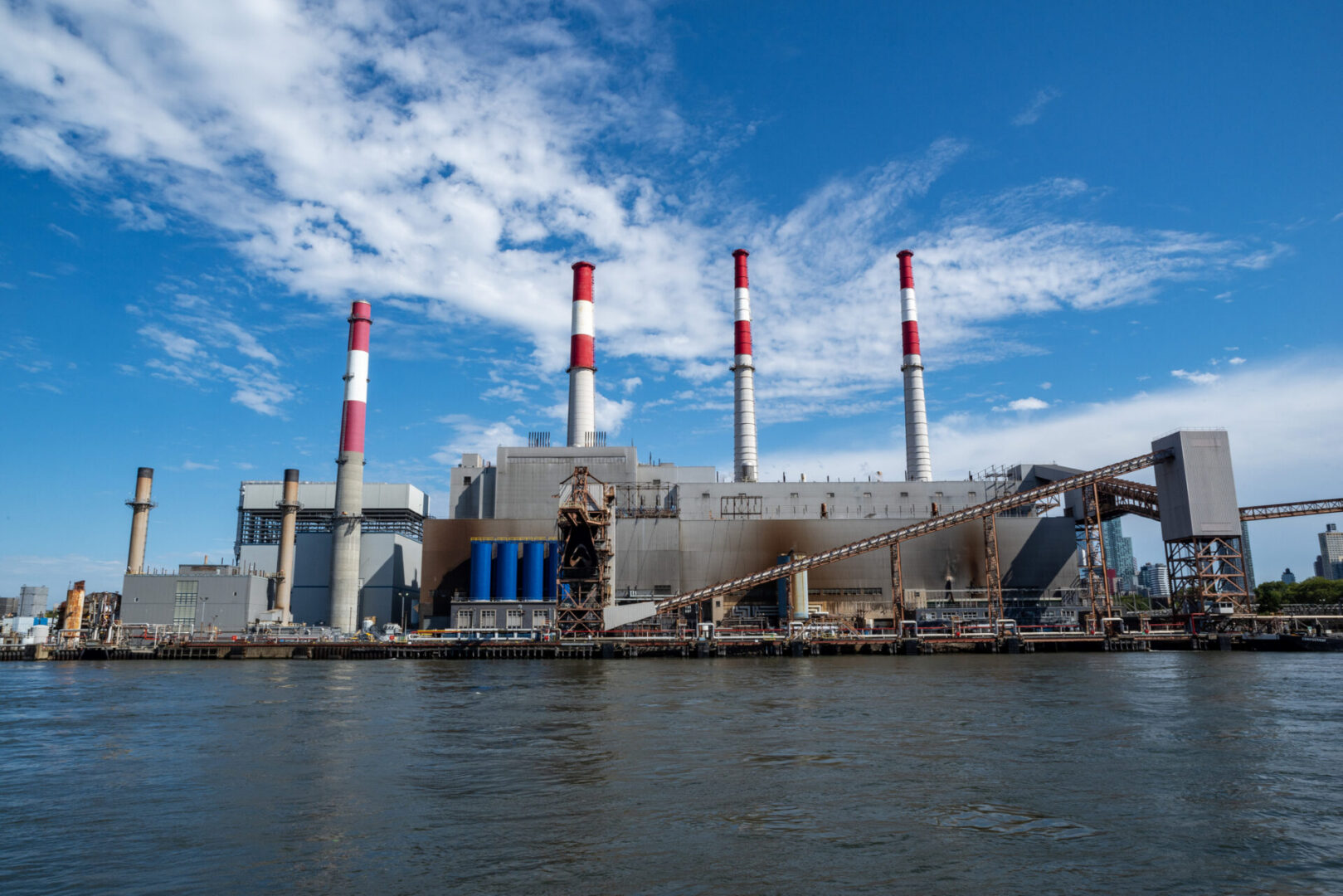 Industrial power plant by the water.