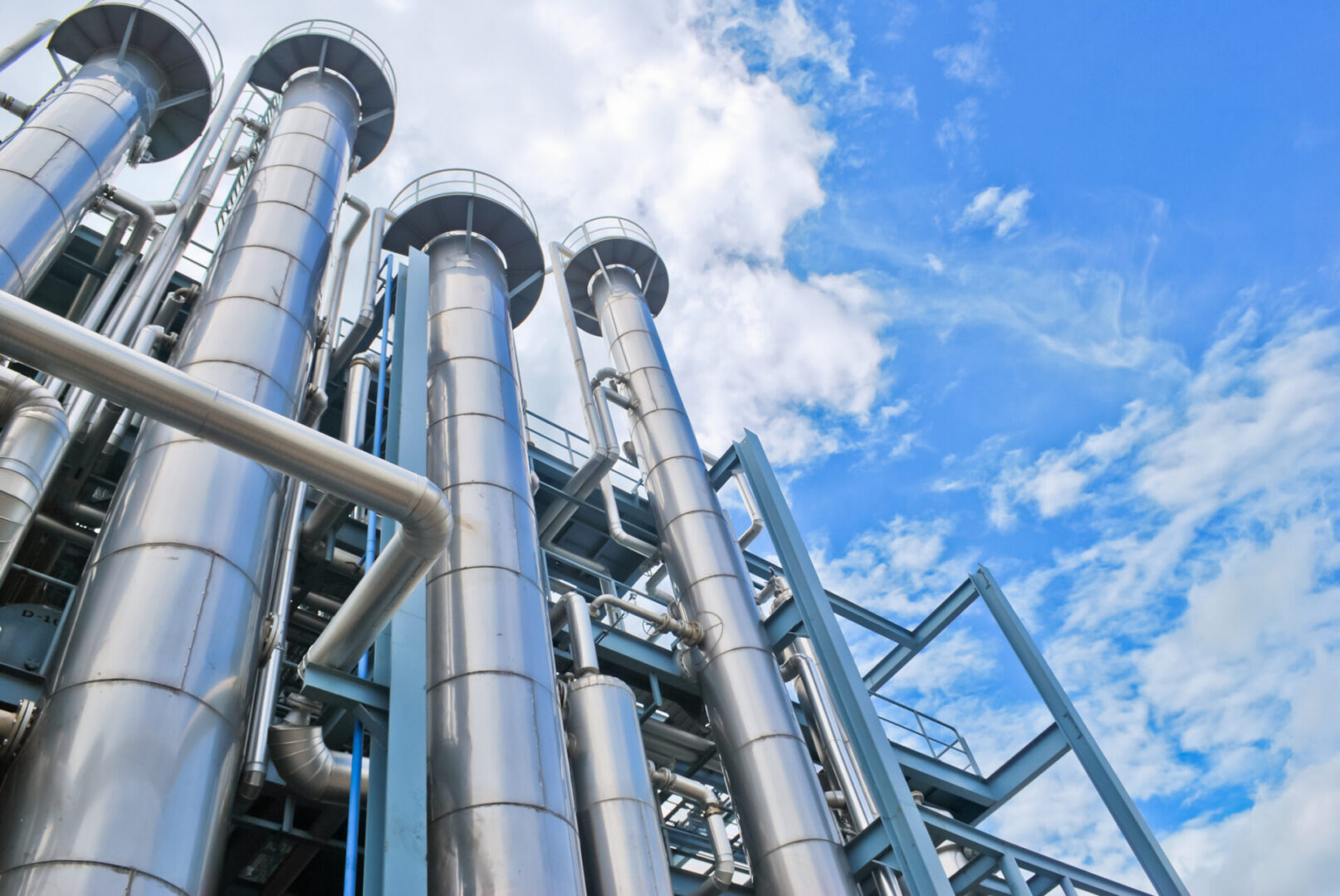 Industrial chimneys against a blue sky background.