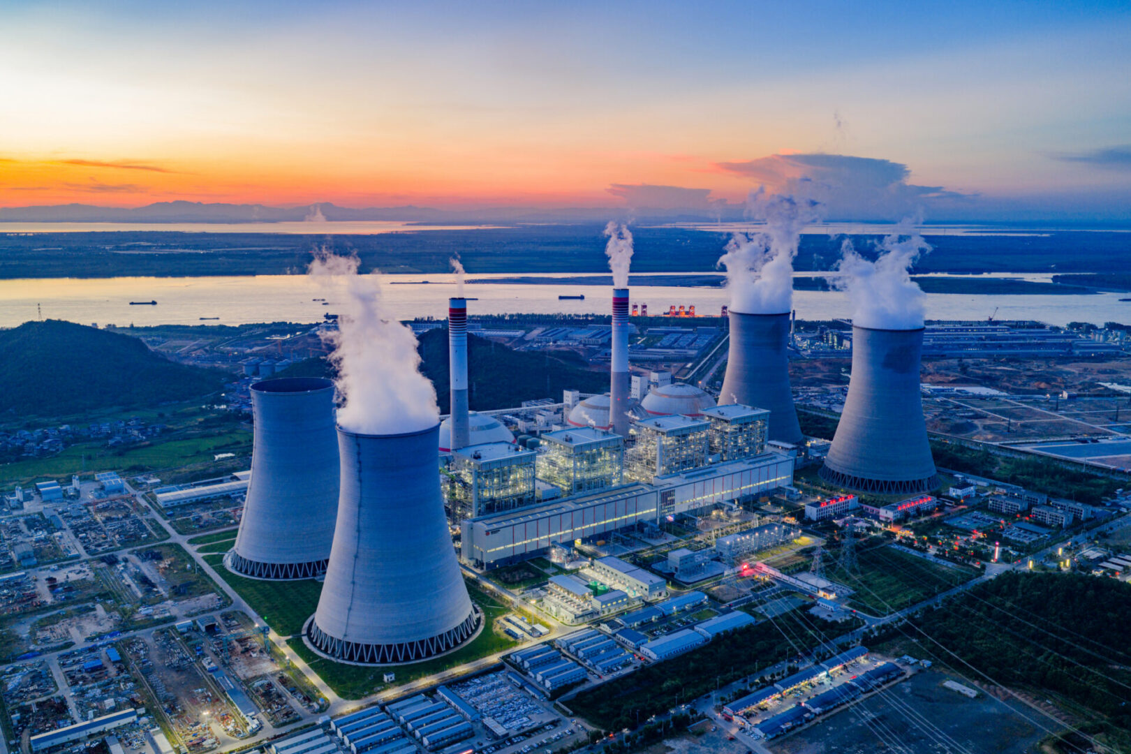 Power plant with cooling towers at sunset.