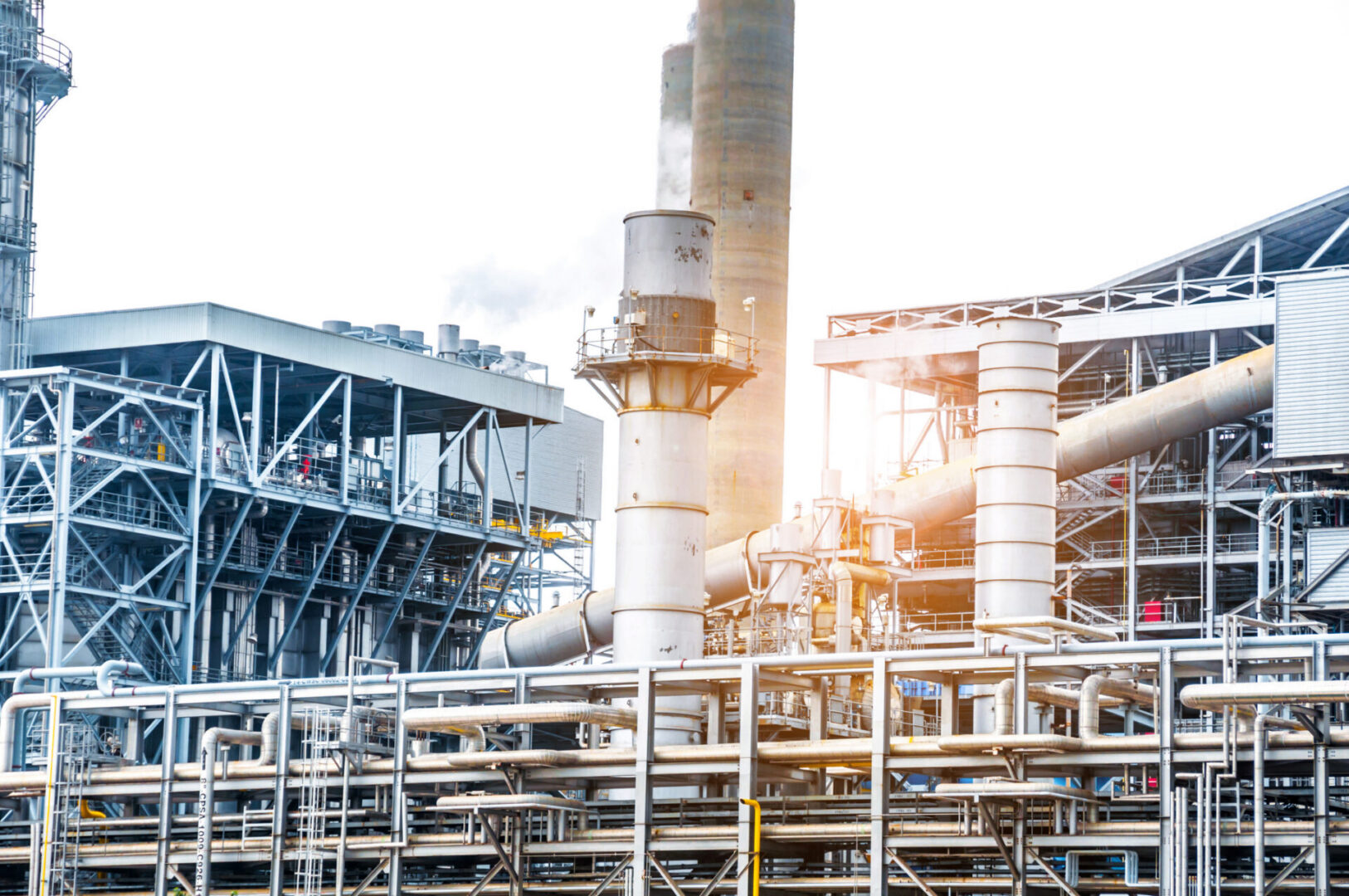 Industrial plant with pipes and smokestacks.