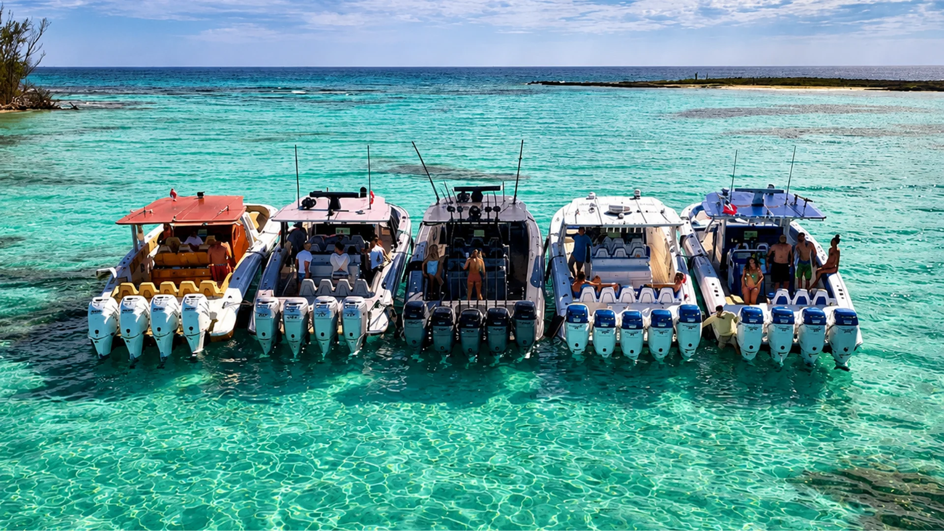 Four boats anchored in clear turquoise water.