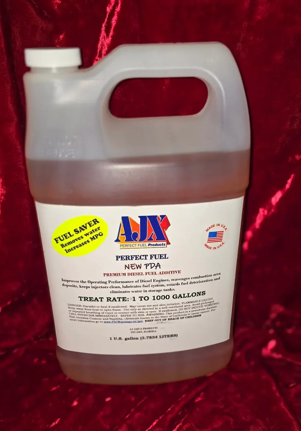 Fuel additive container against red background.